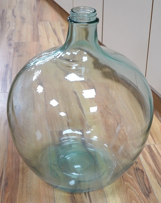 A green glass carboy, 55cm. Condition - good